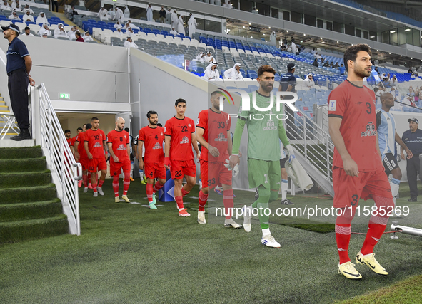 Tractor SC and Al Wakrah players walk onto the pitch before the AFC Champions League Two Group A football match between Qatar's Al Wakrah SC...