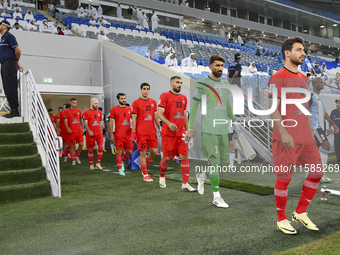 Tractor SC and Al Wakrah players walk onto the pitch before the AFC Champions League Two Group A football match between Qatar's Al Wakrah SC...