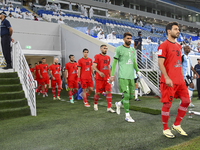 Tractor SC and Al Wakrah players walk onto the pitch before the AFC Champions League Two Group A football match between Qatar's Al Wakrah SC...