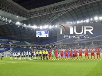 Tractor SC and Al Wakrah teams line up prior to the AFC Champions League Two Group A football match between Qatar's Al Wakrah SC and Iran's...