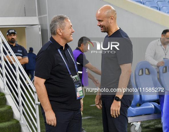 Dragan Skocic, head coach of Tractor SC, and Miguel Angel Ramirez Medina, head coach of Al Wakrah SC, react prior to the AFC Champions Leagu...