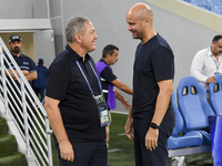 Dragan Skocic, head coach of Tractor SC, and Miguel Angel Ramirez Medina, head coach of Al Wakrah SC, react prior to the AFC Champions Leagu...