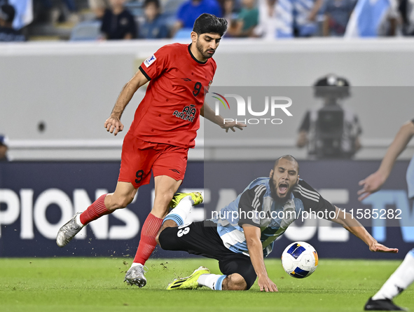 Aissa Belal Laidouni (R) of Al Wakrah SC battles for the ball with Mahdi Torabi of Tractor SC during the AFC Champions League football match...