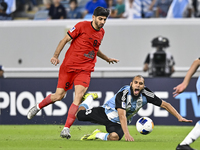 Aissa Belal Laidouni (R) of Al Wakrah SC battles for the ball with Mahdi Torabi of Tractor SC during the AFC Champions League football match...