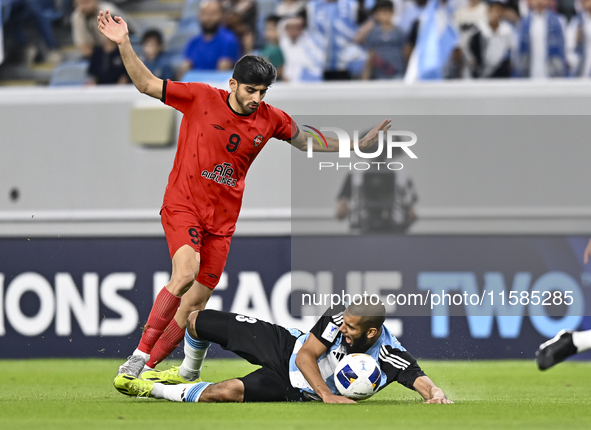 Aissa Belal Laidouni (R) of Al Wakrah SC battles for the ball with Mahdi Torabi of Tractor SC during the AFC Champions League football match...