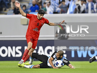 Aissa Belal Laidouni (R) of Al Wakrah SC battles for the ball with Mahdi Torabi of Tractor SC during the AFC Champions League football match...