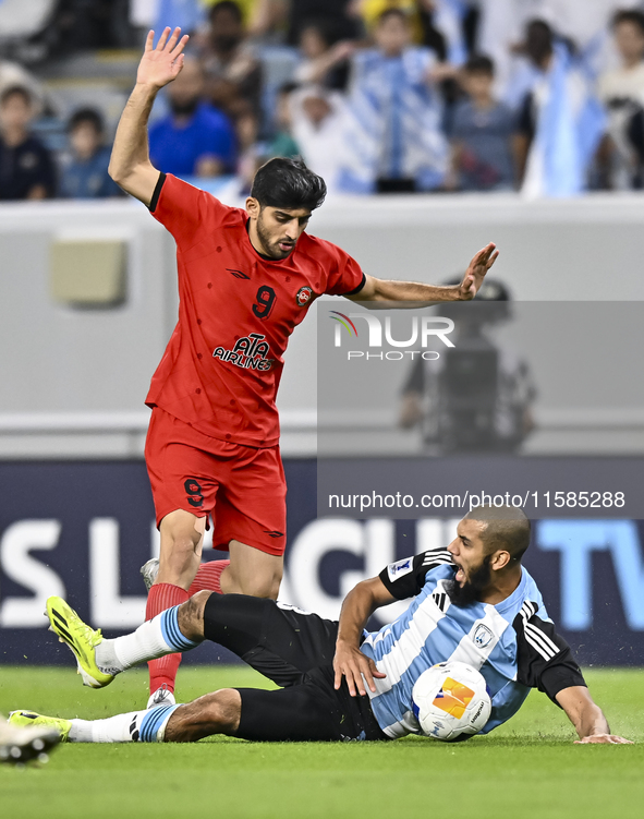 Aissa Belal Laidouni (R) of Al Wakrah SC battles for the ball with Mahdi Torabi of Tractor SC during the AFC Champions League football match...