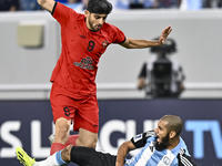 Aissa Belal Laidouni (R) of Al Wakrah SC battles for the ball with Mahdi Torabi of Tractor SC during the AFC Champions League football match...