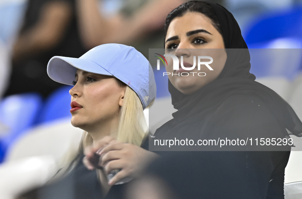 Tractor SC supporters cheer for their team during the AFC Champions League Two Group A football match between Qatar's Al Wakrah SC and Iran'...