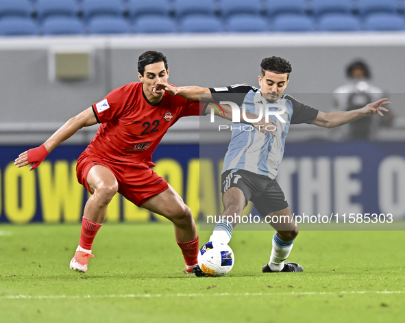 Ayoub Assal (R) of Al Wakrah SC battles for the ball with Mohammad Naderi of Tractor SC during the AFC Champions League elite football match...