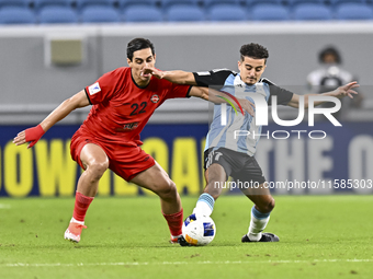 Ayoub Assal (R) of Al Wakrah SC battles for the ball with Mohammad Naderi of Tractor SC during the AFC Champions League elite football match...