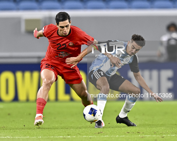 Ayoub Assal (R) of Al Wakrah SC battles for the ball with Mohammad Naderi of Tractor SC during the AFC Champions League elite football match...