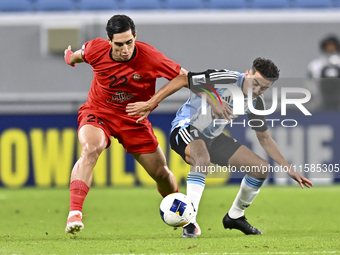 Ayoub Assal (R) of Al Wakrah SC battles for the ball with Mohammad Naderi of Tractor SC during the AFC Champions League elite football match...