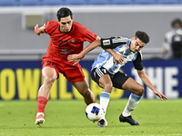 Ayoub Assal (R) of Al Wakrah SC battles for the ball with Mohammad Naderi of Tractor SC during the AFC Champions League elite football match...