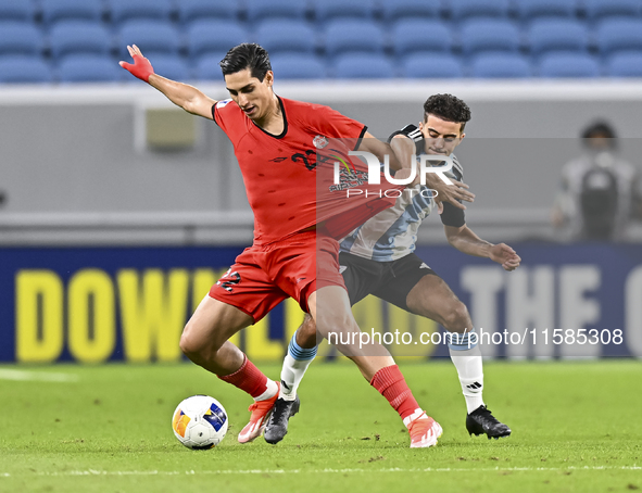 Ayoub Assal (R) of Al Wakrah SC battles for the ball with Mohammad Naderi of Tractor SC during the AFC Champions League elite football match...