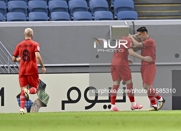 Tomislav Strkalj (2nd R) of Tractor SC celebrates with his teammates after scoring the opening goal during the AFC Champions League football...