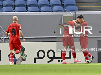 Tomislav Strkalj (2nd R) of Tractor SC celebrates with his teammates after scoring the opening goal during the AFC Champions League football...