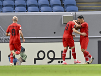 Tomislav Strkalj (2nd R) of Tractor SC celebrates with his teammates after scoring the opening goal during the AFC Champions League football...