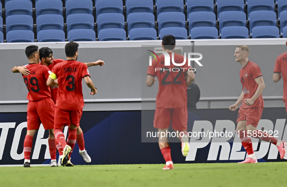 Mahdi Torabi (2-L) of Tractor SC celebrates after scoring the second goal during the AFC Champions League football match between Qatar's Al...