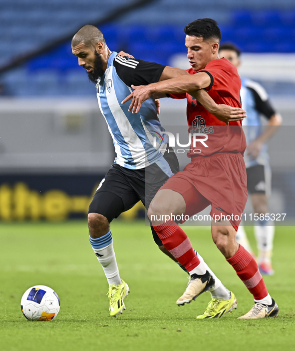 Aissa Belal Laidouni of Al Wakrah SC battles for the ball with Amirhossein Hosseinzadeh of Tractor SC during the AFC Champions League footba...