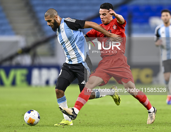 Aissa Belal Laidouni of Al Wakrah SC battles for the ball with Amirhossein Hosseinzadeh of Tractor SC during the AFC Champions League footba...