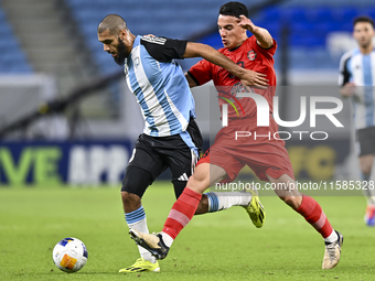 Aissa Belal Laidouni of Al Wakrah SC battles for the ball with Amirhossein Hosseinzadeh of Tractor SC during the AFC Champions League footba...