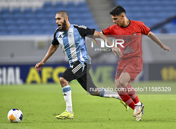 Aissa Belal Laidouni of Al Wakrah SC battles for the ball with Amirhossein Hosseinzadeh of Tractor SC during the AFC Champions League footba...