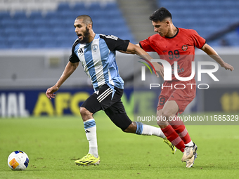 Aissa Belal Laidouni of Al Wakrah SC battles for the ball with Amirhossein Hosseinzadeh of Tractor SC during the AFC Champions League footba...