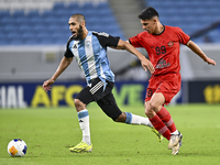 Aissa Belal Laidouni of Al Wakrah SC battles for the ball with Amirhossein Hosseinzadeh of Tractor SC during the AFC Champions League footba...