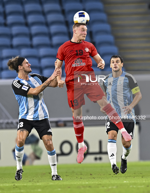 Alexander Scholz of Al Wakrah SC battles for the ball with Tomislav Strkalj of Tractor SC during the AFC Champions League football match bet...