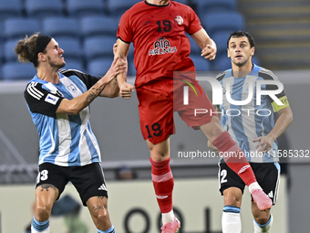 Alexander Scholz of Al Wakrah SC battles for the ball with Tomislav Strkalj of Tractor SC during the AFC Champions League football match bet...