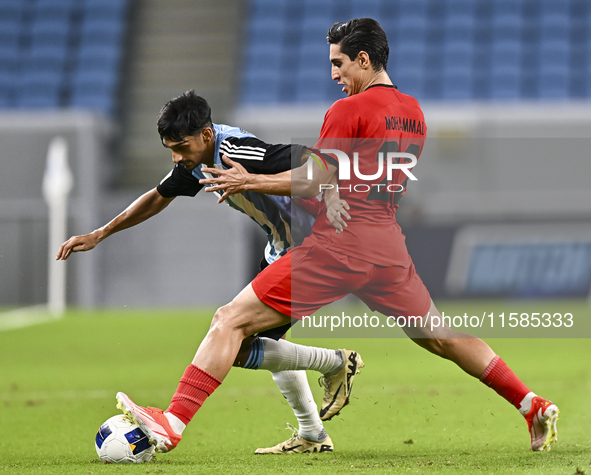 Nabil Irfan of Al Wakrah SC battles for the ball with Mohammad Naderi of Tractor SC during the AFC Champions League football match between A...