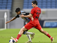 Nabil Irfan of Al Wakrah SC battles for the ball with Mohammad Naderi of Tractor SC during the AFC Champions League football match between A...