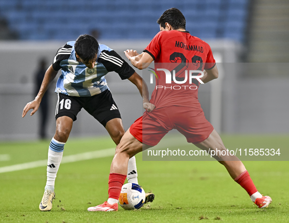 Nabil Irfan of Al Wakrah SC battles for the ball with Mohammad Naderi of Tractor SC during the AFC Champions League football match between A...