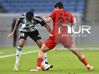 Nabil Irfan of Al Wakrah SC battles for the ball with Mohammad Naderi of Tractor SC during the AFC Champions League football match between A...