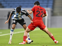 Nabil Irfan of Al Wakrah SC battles for the ball with Mohammad Naderi of Tractor SC during the AFC Champions League football match between A...