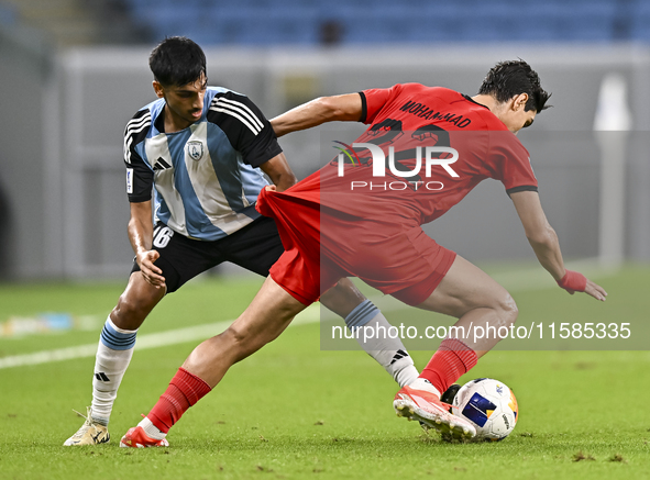 Nabil Irfan of Al Wakrah SC battles for the ball with Mohammad Naderi of Tractor SC during the AFC Champions League football match between A...