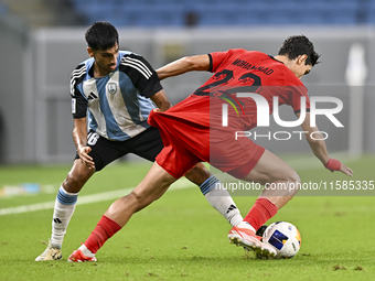 Nabil Irfan of Al Wakrah SC battles for the ball with Mohammad Naderi of Tractor SC during the AFC Champions League football match between A...