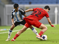 Nabil Irfan of Al Wakrah SC battles for the ball with Mohammad Naderi of Tractor SC during the AFC Champions League football match between A...