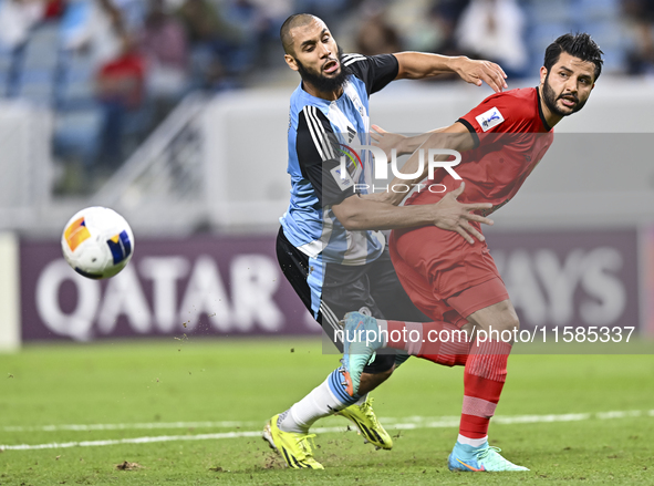 Aissa Belal Laidouni of Al Wakrah SC battles for the ball with Aref Gholami of Tractor SC during the AFC Champions League football match bet...