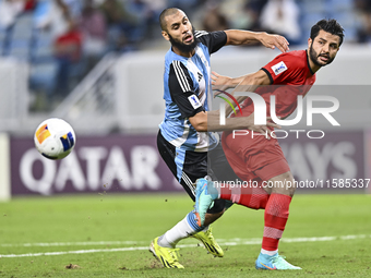 Aissa Belal Laidouni of Al Wakrah SC battles for the ball with Aref Gholami of Tractor SC during the AFC Champions League football match bet...