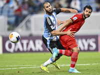 Aissa Belal Laidouni of Al Wakrah SC battles for the ball with Aref Gholami of Tractor SC during the AFC Champions League football match bet...