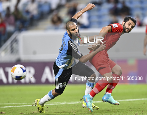 Aissa Belal Laidouni of Al Wakrah SC battles for the ball with Aref Gholami of Tractor SC during the AFC Champions League football match bet...