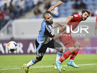 Aissa Belal Laidouni of Al Wakrah SC battles for the ball with Aref Gholami of Tractor SC during the AFC Champions League football match bet...