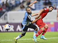 Aissa Belal Laidouni of Al Wakrah SC battles for the ball with Aref Gholami of Tractor SC during the AFC Champions League football match bet...