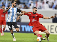 Farid Boulaya of Al Wakrah SC battles for the ball with Aref Aghasi of Tractor SC during the AFC Champions League football match between Al...