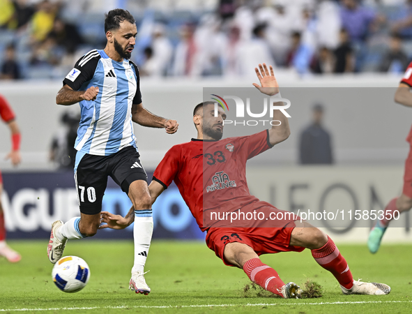 Farid Boulaya of Al Wakrah SC battles for the ball with Aref Aghasi of Tractor SC during the AFC Champions League football match between Al...