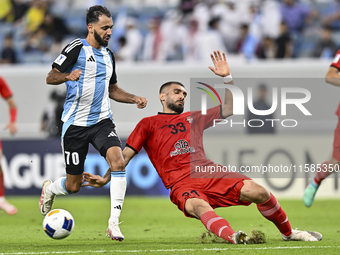 Farid Boulaya of Al Wakrah SC battles for the ball with Aref Aghasi of Tractor SC during the AFC Champions League football match between Al...