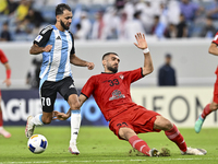 Farid Boulaya of Al Wakrah SC battles for the ball with Aref Aghasi of Tractor SC during the AFC Champions League football match between Al...