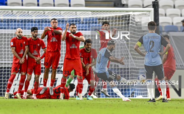 Tractor SC players block a free kick by Farid Boulaya of Al Wakrah SC during the AFC Champions League football match between Al Wakrah SC an...